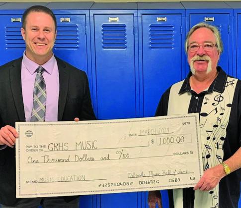 Courtesy Photo Gordon-Rushville High School Principal Dr. Dennis Dolezal (left) and GRHS Music Instructor George Meng (right) show off a big check to commemorate a $1,000 donation to the Music Department from the Nebraska Music Hall of Fame. The NMHOF makes several donations each year to help further the efforts of music education in Nebraska.