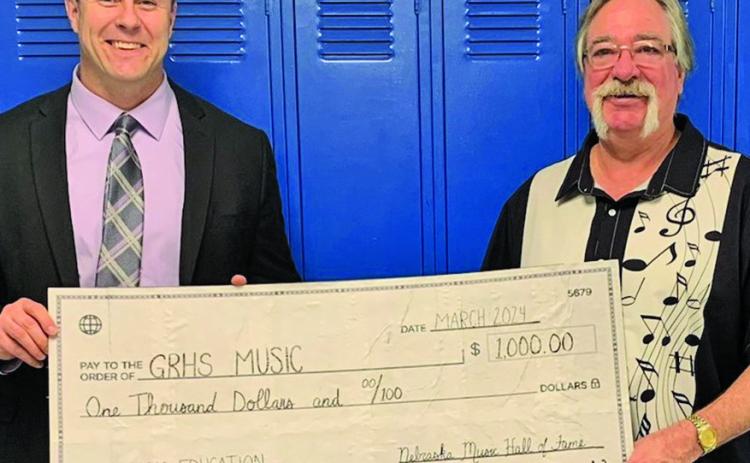 Courtesy Photo Gordon-Rushville High School Principal Dr. Dennis Dolezal (left) and GRHS Music Instructor George Meng (right) show off a big check to commemorate a $1,000 donation to the Music Department from the Nebraska Music Hall of Fame. The NMHOF makes several donations each year to help further the efforts of music education in Nebraska.