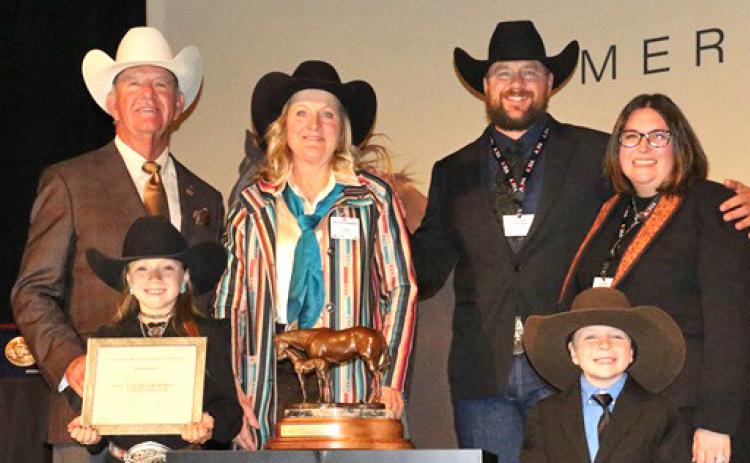 Courtesy Photo BOXO Quarter Horses, which is based in central Sheridan County, was named the AQHA 2023 Top Money-Earning Ranching Heritage Breeder of the Year. Included in the photo are: (LR) 2023 AQHA President Ken Banks, Tenley Ostrander, Jecca Ostrander, Stetson Ostrander, Courtney Ostrander, and Jensen Ostrander. Not pictured: Cash Ostrander