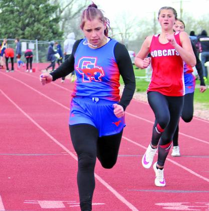 Photo by Con Marshall Sophomore Lainey Fillmore pushes through the finish line in the 100 meter dash. Fillmore would set a personal best in the event and finish in first place.