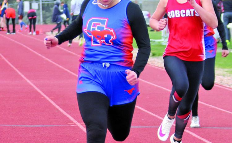 Photo by Con Marshall Sophomore Lainey Fillmore pushes through the finish line in the 100 meter dash. Fillmore would set a personal best in the event and finish in first place.